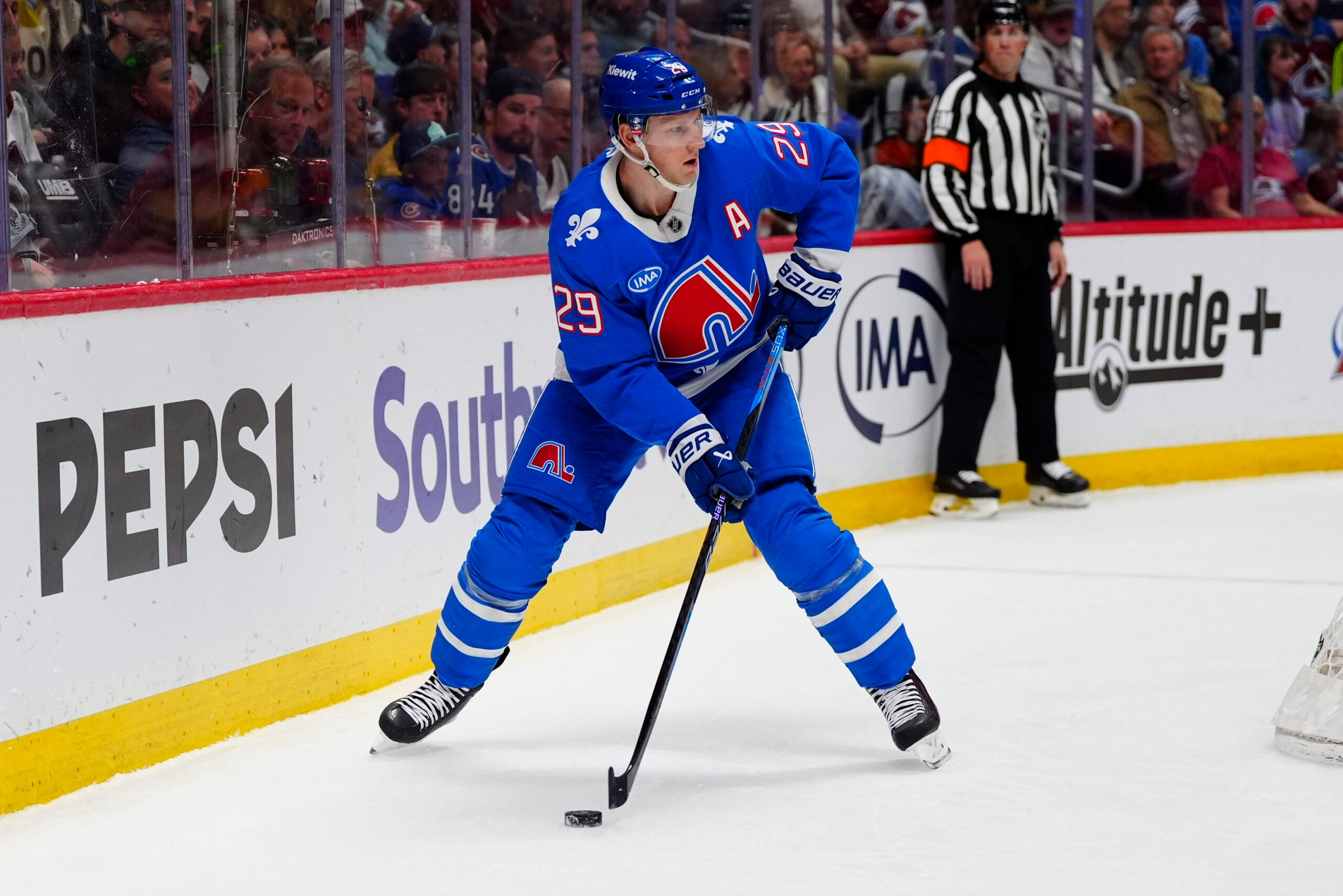 Apr 11, 2026; Denver, Colorado, USA; Colorado Avalanche center Nathan MacKinnon (29) controls the puck in the second period against the Vegas Golden Knights  at Ball Arena. Mandatory Credit: Ron Chenoy-Imagn Images