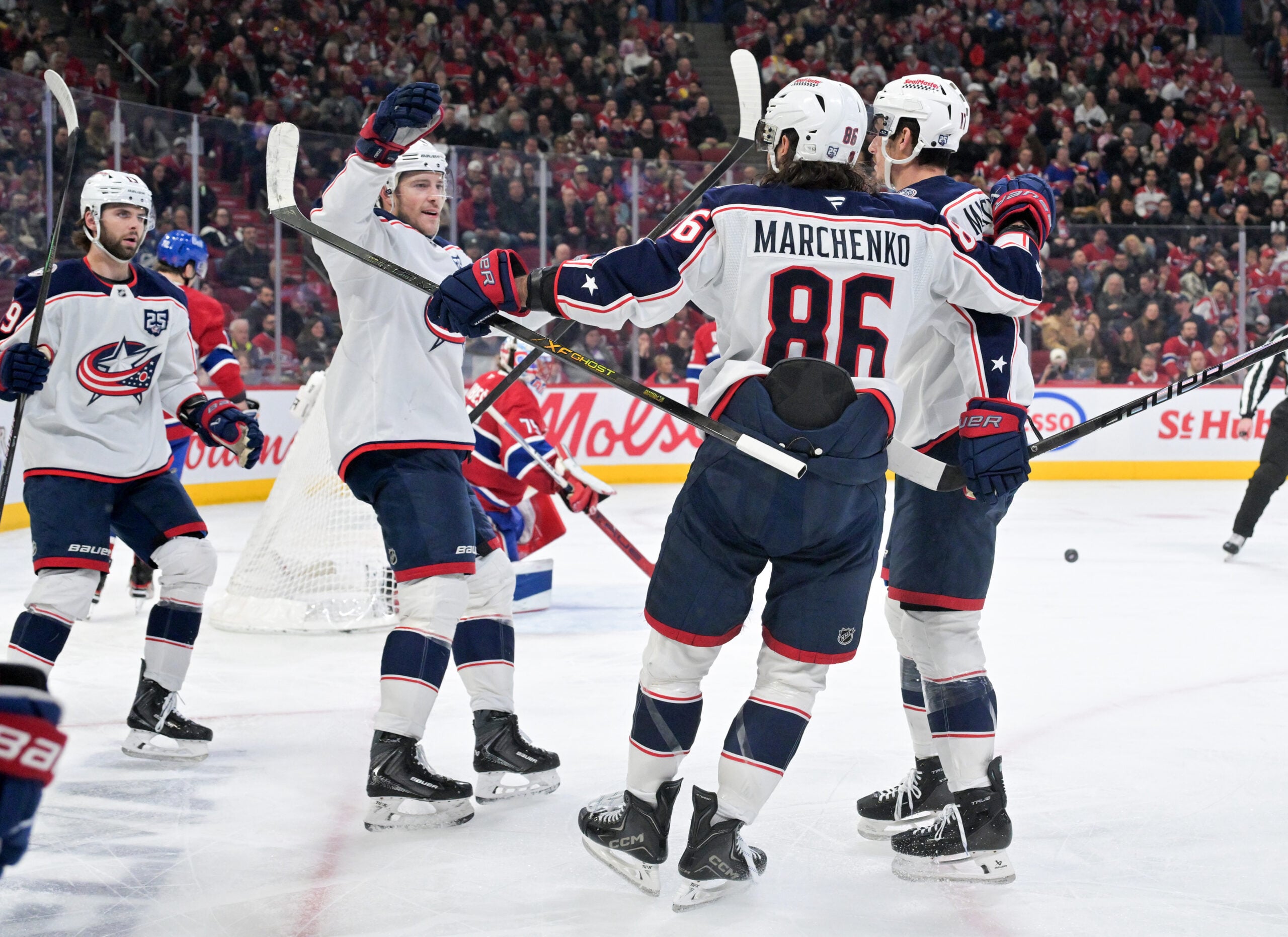 Apr 11, 2026; Montreal, Quebec, CAN; Columbus Blue Jackets forward Charlie Coyle (3) celebrates with teammates after scoring a goal against Montreal Canadiens goalie Jakub Dobes (75) during the third period at the Bell Centre. Mandatory Credit: Eric Bolte-Imagn Images