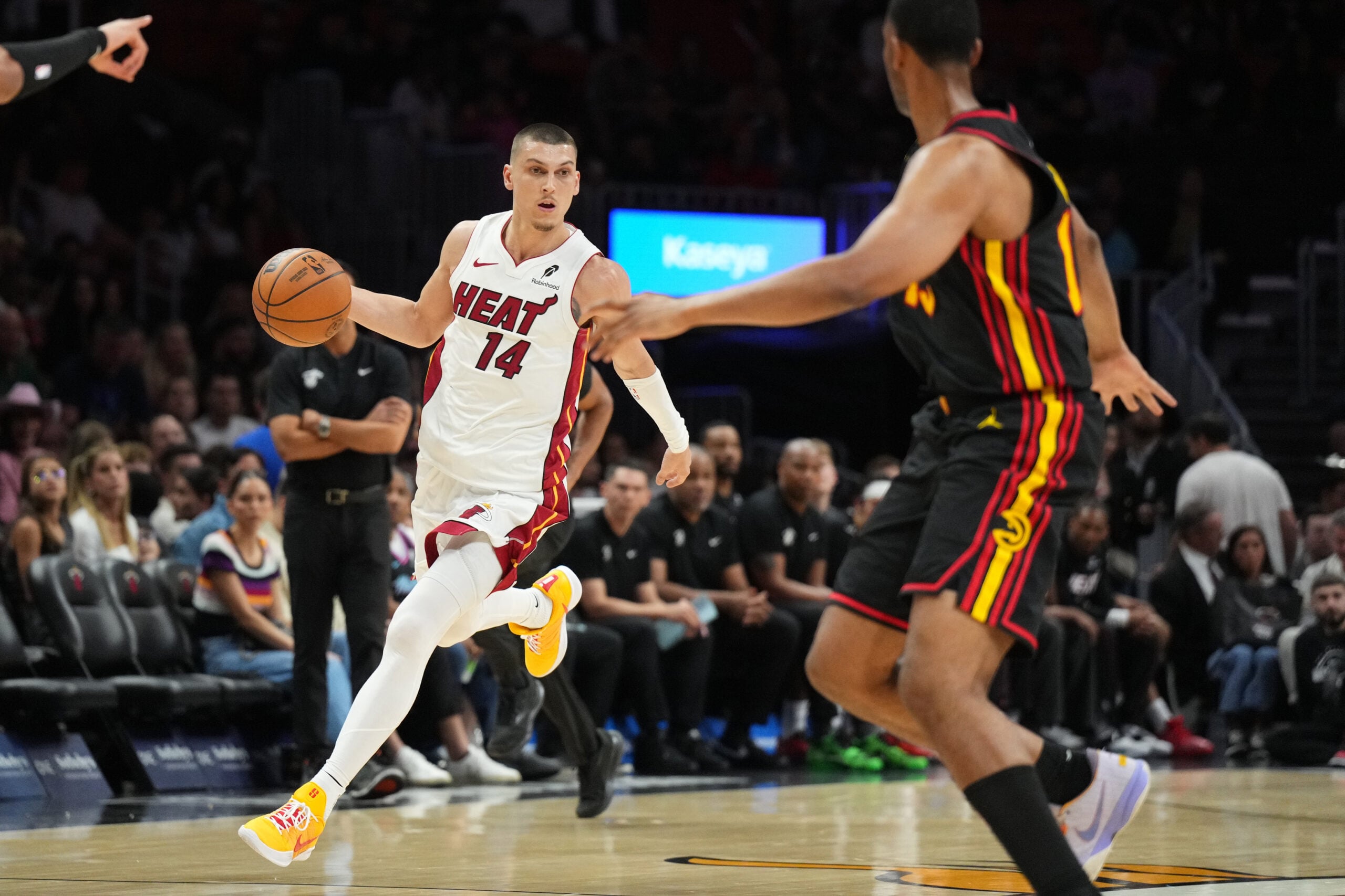 Apr 12, 2026; Miami, Florida, USA;  Miami Heat guard Tyler Herro (14) dribbles against Atlanta Hawks forward Asa Newell (14) during the second half at Kaseya Center. Mandatory Credit: Jim Rassol-Imagn Images