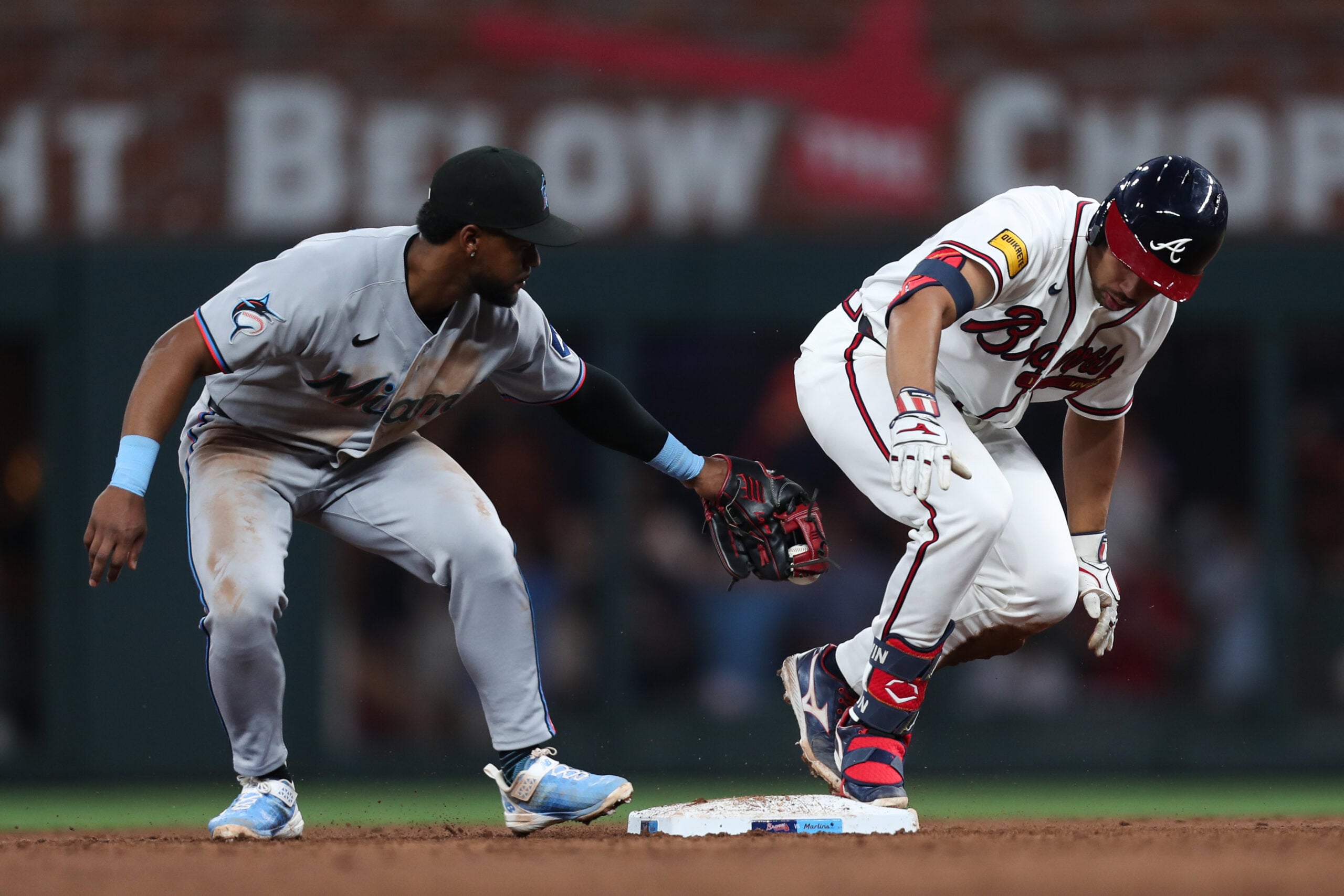 Apr 14, 2026; Cumberland, Georgia, USA; Atlanta Braves catcher Drake Baldwin (30) is safe on second base next to Miami Marlins shortstop Xavier Edwards (9) in the third inning at Truist Park. Mandatory Credit: Mady Mertens-Imagn Images