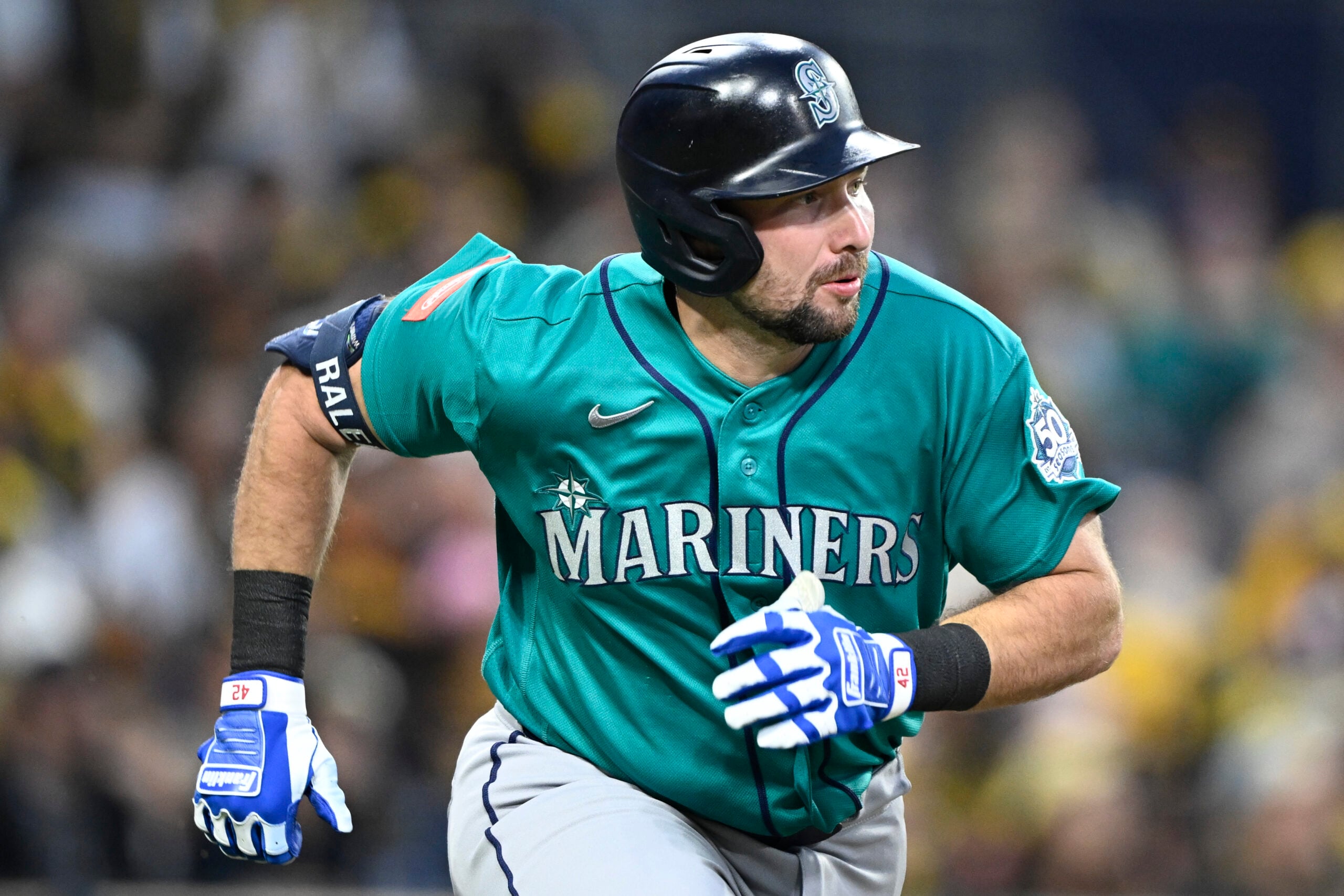Apr 15, 2026; San Diego, California, USA; Seattle Mariners catcher Cal Raleigh hits a double during the third inning against the San Diego Padres at Petco Park. All MLB players are wearing number 42 today to honor Jackie Robinson. Mandatory Credit: Denis Poroy-Imagn Images