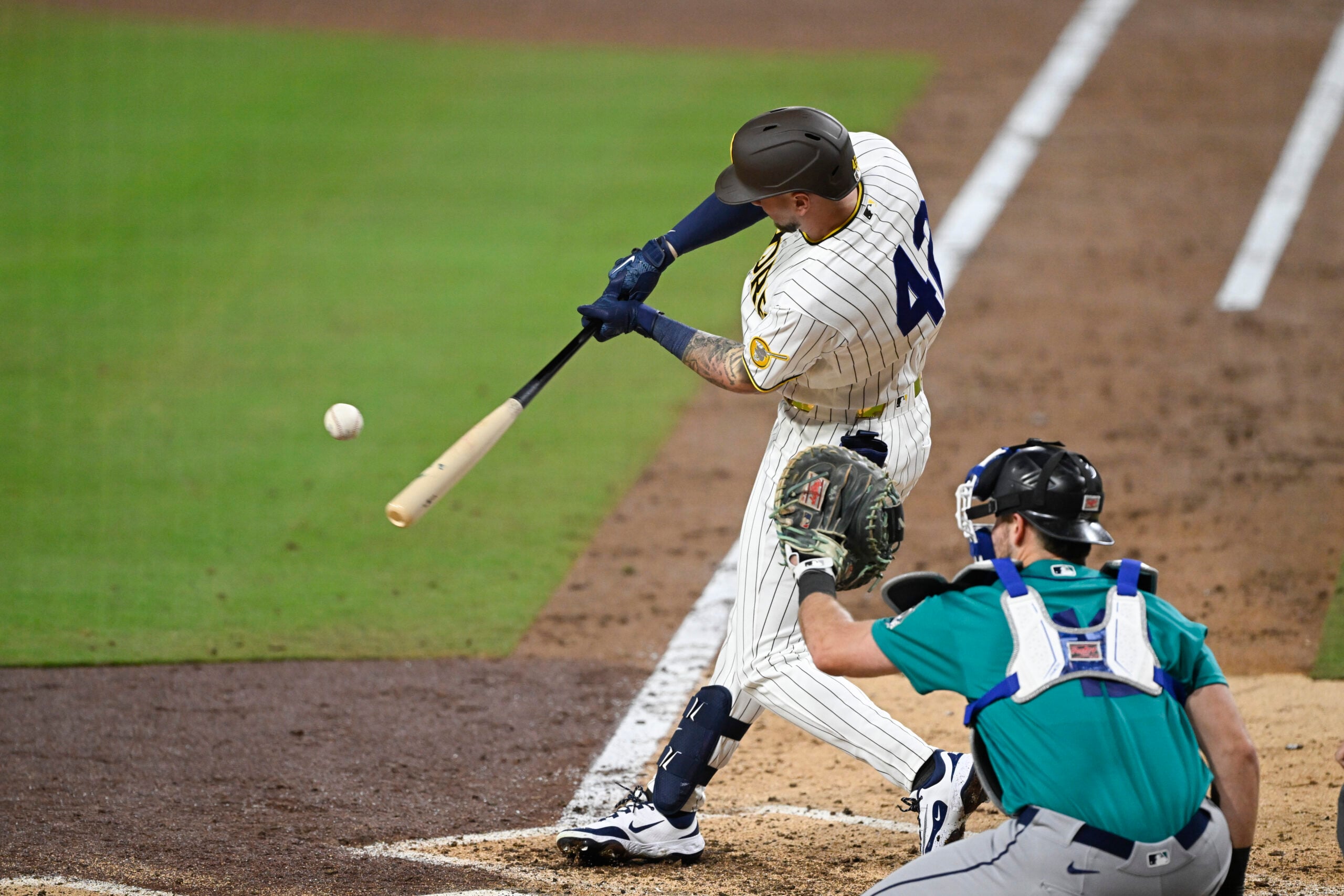 Apr 15, 2026; San Diego, California, USA; San Diego Padres center fielder Jackson Merrill hits a single during the sixth inning against the Seattle Mariners at Petco Park. All MLB players are wearing number 42 today to honor Jackie Robinson. Mandatory Credit: Denis Poroy-Imagn Images