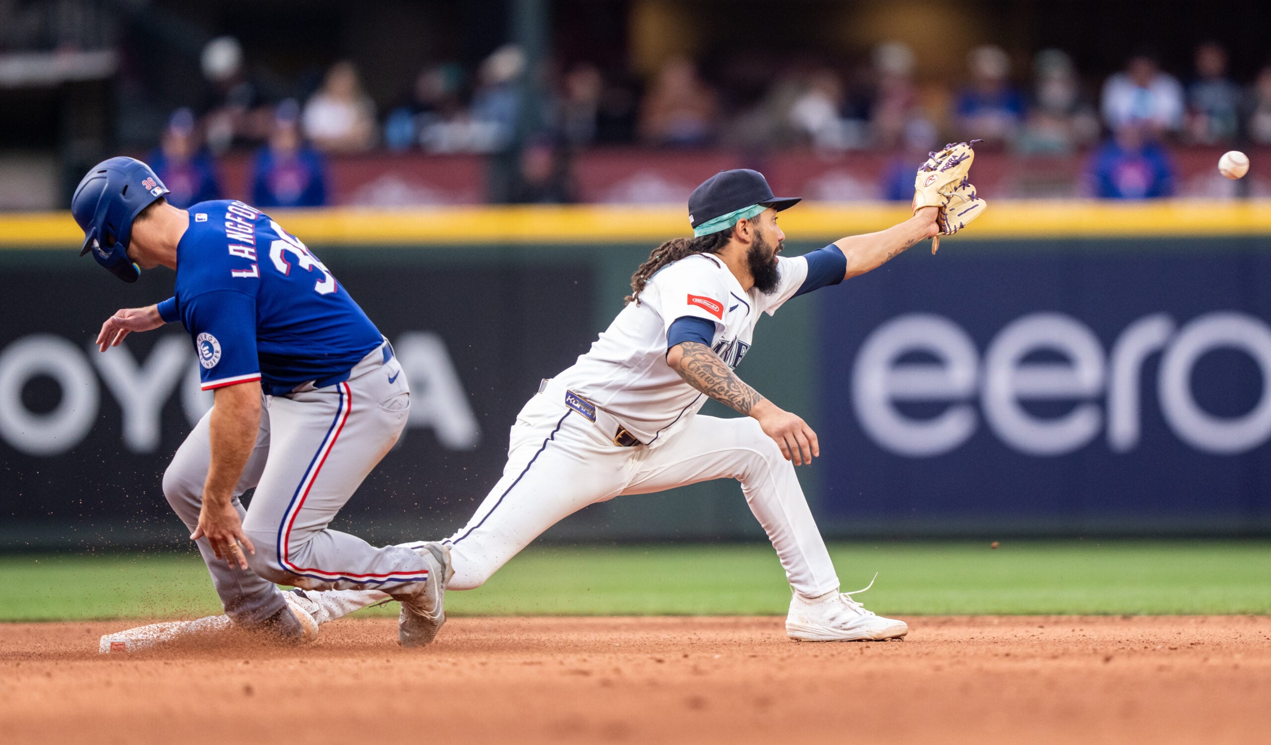 Apr 18, 2026; Seattle, Washington, USA; Texas Rangers left fielder Wyatt Langford (36) slides safely into second base ahead of a throw to Seattle Mariners shortstop J.P. Crawford (3) during the ninth inning at T-Mobile Park. Mandatory Credit: Stephen Brashear-Imagn Images