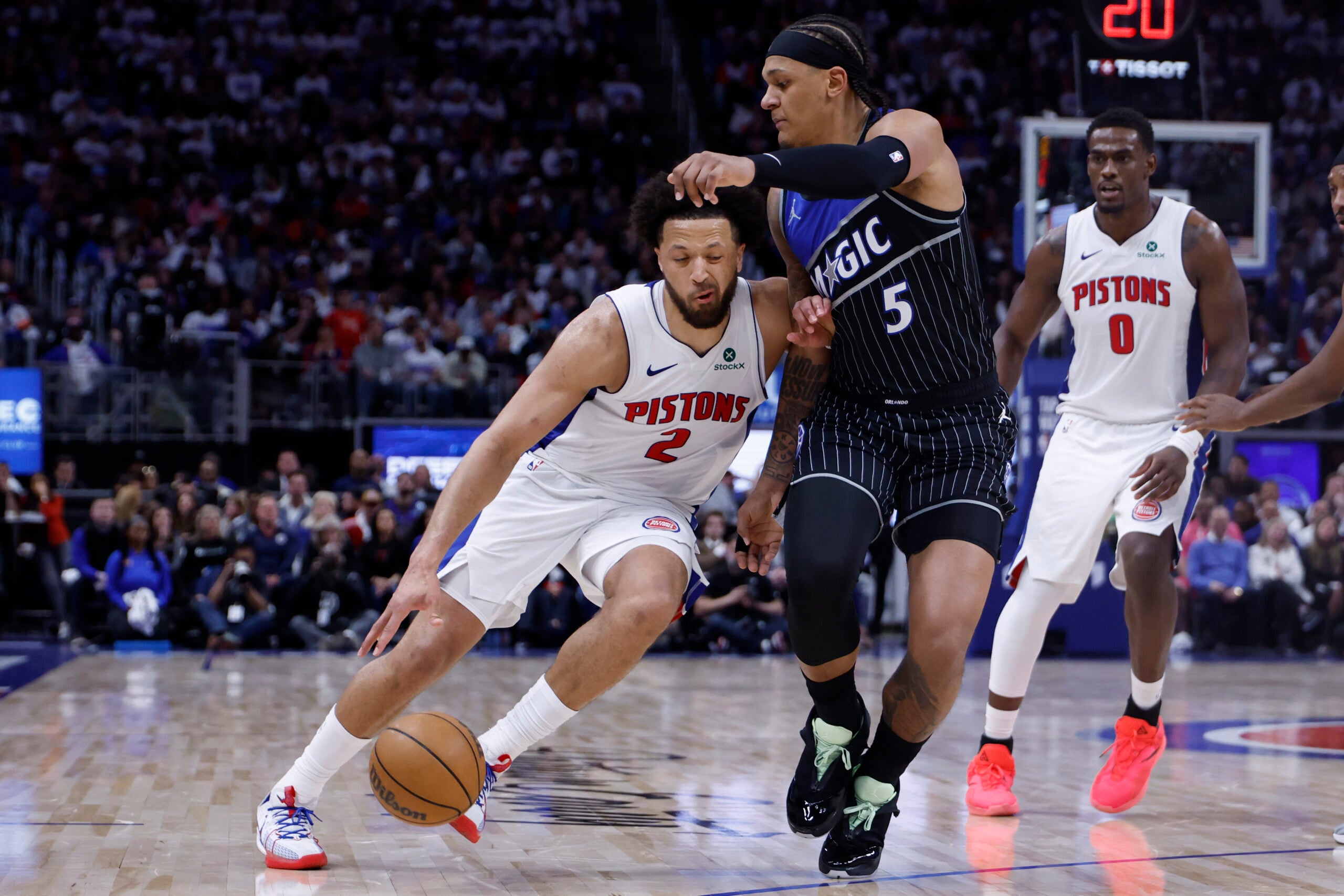 Apr 19, 2026; Detroit, Michigan, USA; Detroit Pistons guard Cade Cunningham (2) dribbles defended by Orlando Magic forward Paolo Banchero (5) in the second half during the 2026 NBA Playoffs at Little Caesars Arena. Mandatory Credit: Rick Osentoski-Imagn Images