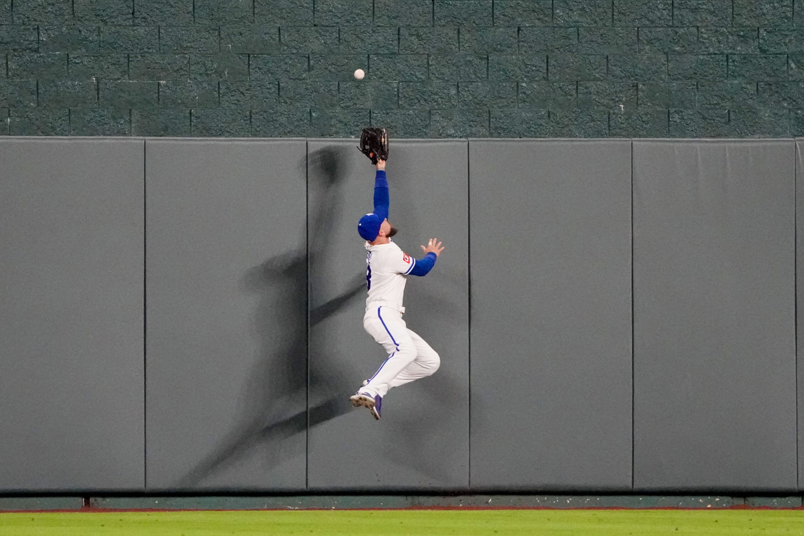 Apr 20, 2026; Kansas City, Missouri, USA; Kansas City Royals center fielder Kyle Isbel (28) leaps for but misses a grand slam ball hit by Baltimore Orioles center fielder Leody Taveras (30) (not pictured) in the twelfth inning at Kauffman Stadium. Mandatory Credit: Denny Medley-Imagn Images
