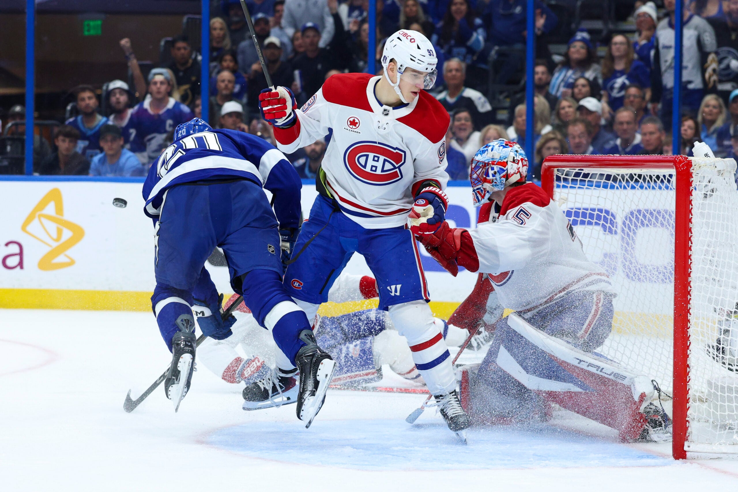 Apr 21, 2026; Tampa, Florida, USA; Tampa Bay Lightning left wing Nick Paul (20) is tipped up in front of the goal by Montreal Canadiens right wing Ivan Demidov (93) in the third period during game two of the first round of the 2026 Stanley Cup Playoffs at Benchmark International Arena. Mandatory Credit: Nathan Ray Seebeck-Imagn Images