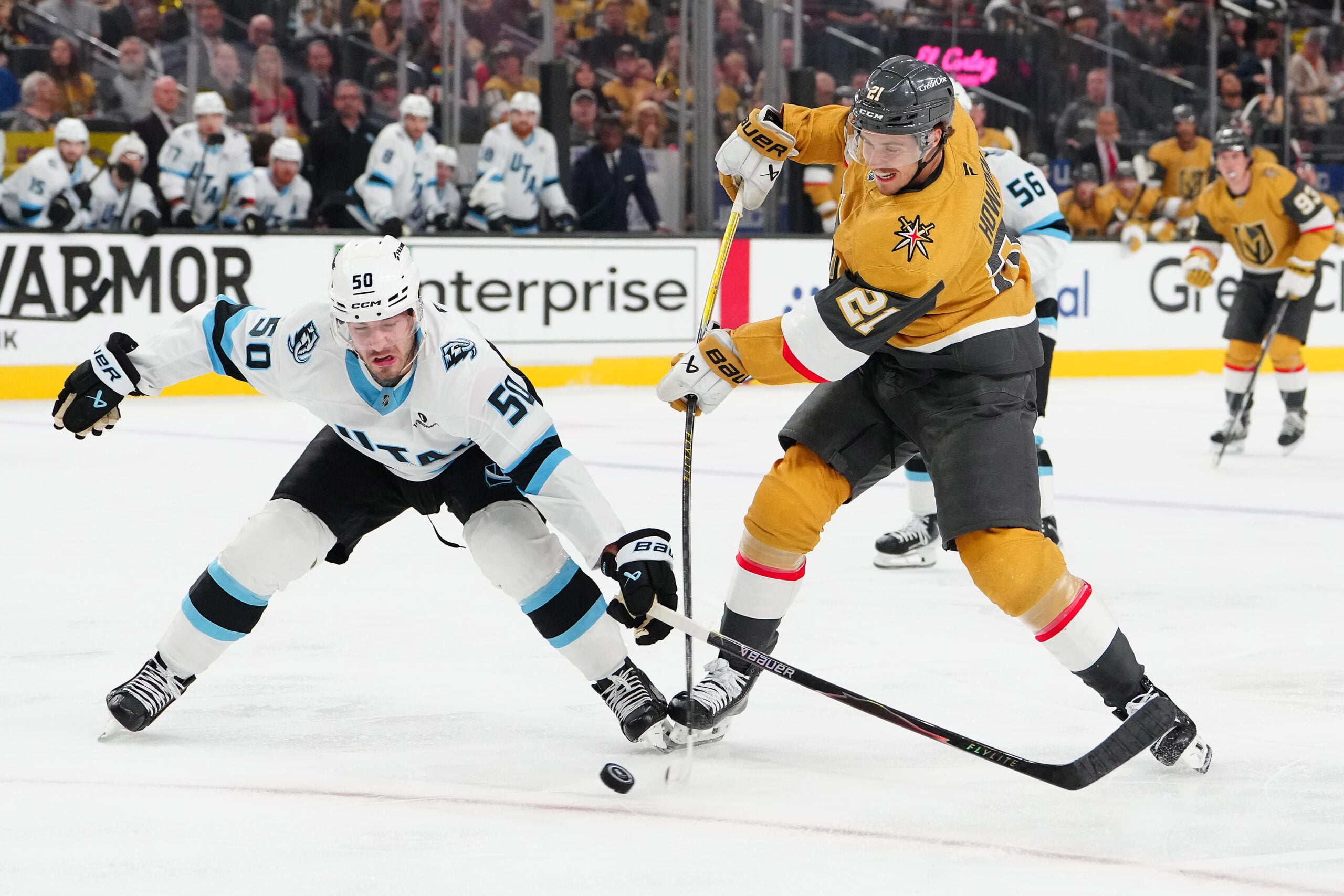 Apr 21, 2026; Las Vegas, Nevada, USA; Utah Mammoth defenseman Sean Durzi (50) attempts to deflect a shot attempt by Vegas Golden Knights center Brett Howden (21) during the first period of game two of the first round of the 2026 Stanley Cup Playoffs at T-Mobile Arena. Mandatory Credit: Stephen R. Sylvanie-Imagn Images