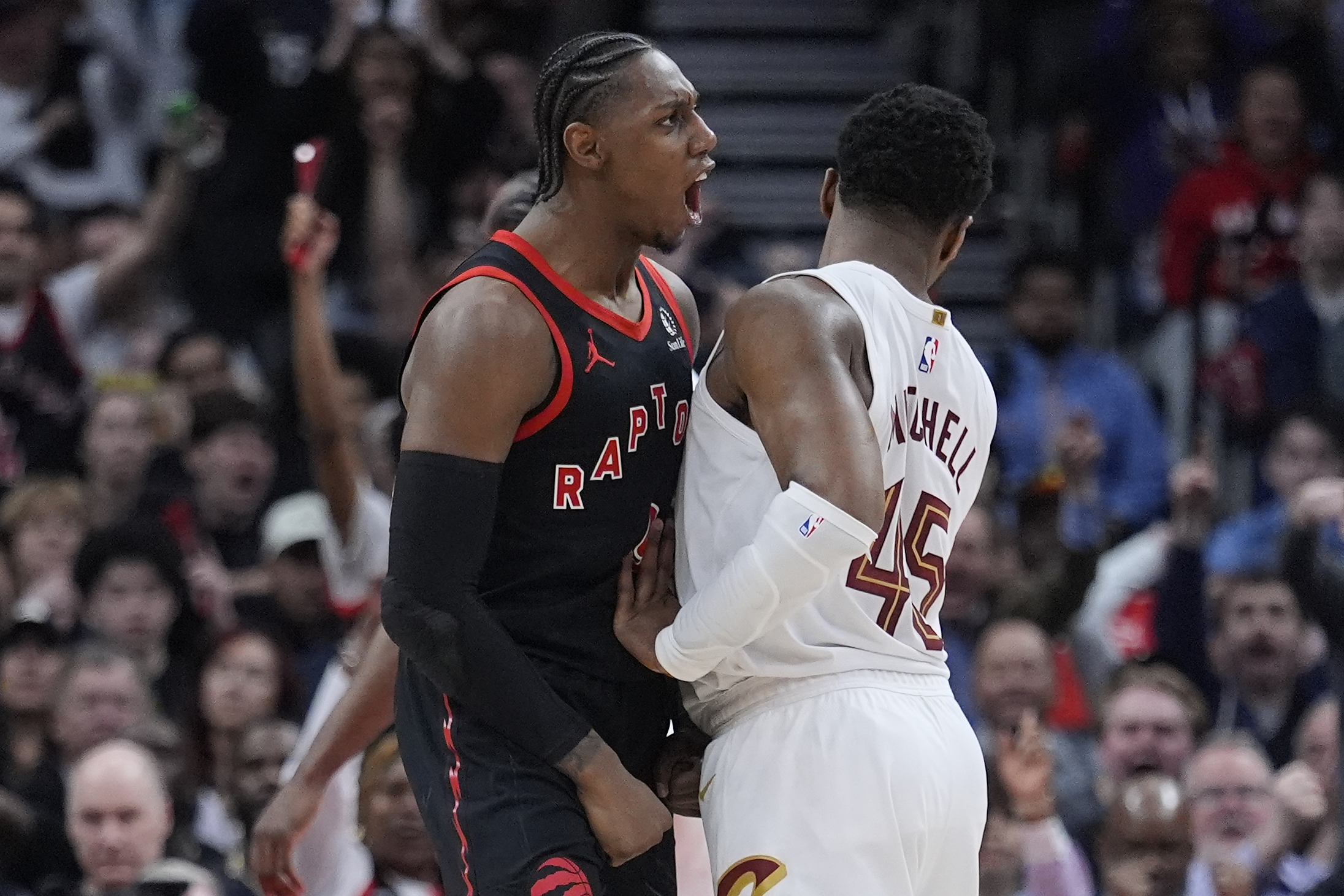Apr 23, 2026; Toronto, Ontario, CAN; Toronto Raptors forward RJ Barrett (9) celebrates as Cleveland Cavaliers guard Donovan Mitchell (45) tries to walk away during the second half of game three of the first round of the 2026 NBA Playoffs at Scotiabank Arena. Mandatory Credit: John E. Sokolowski-Imagn Images