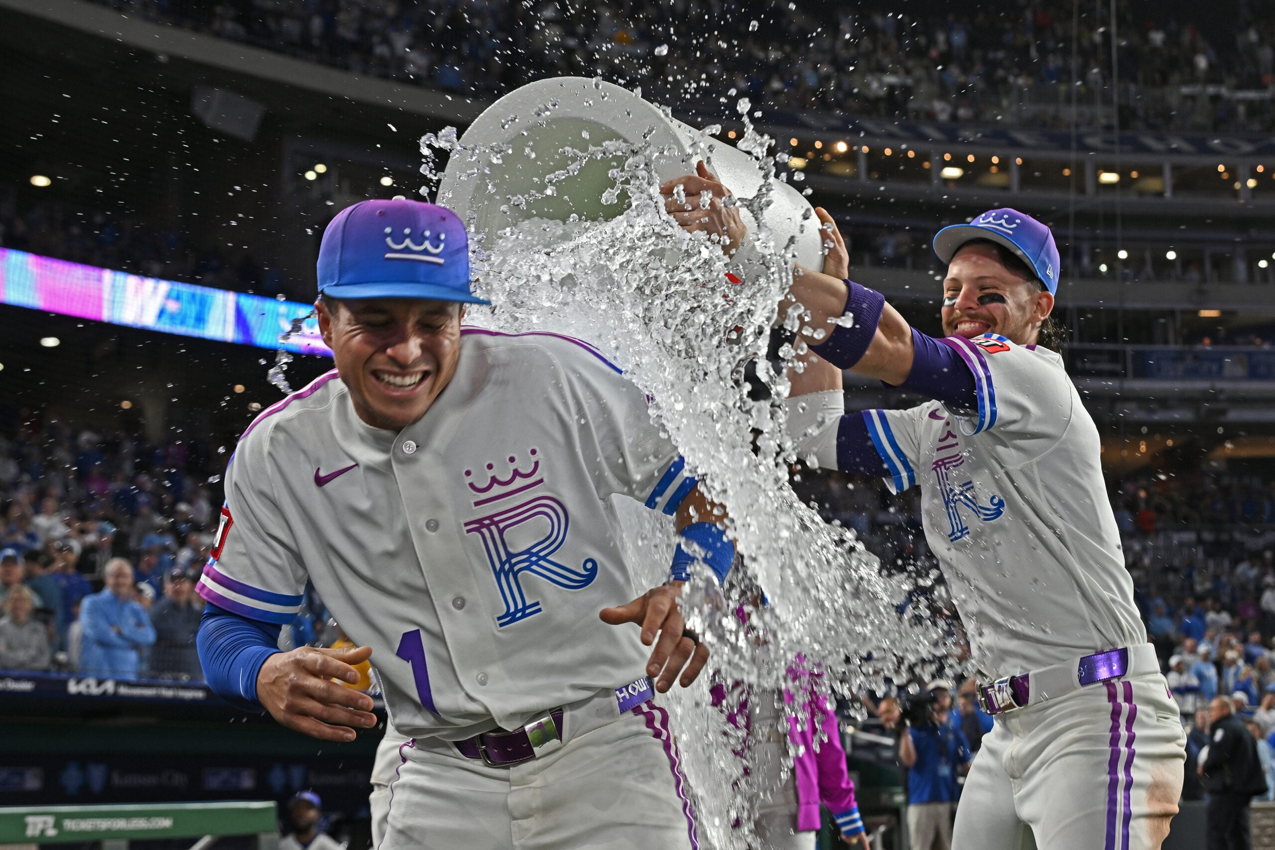 Apr 24, 2026; Kansas City, Missouri, USA;  Kansas City Royals shortstop Bobby Witt Jr. (7) douses left fielder Isaac Collins (1) with ice water after beating the Los Angeles Angels at Kauffman Stadium. Mandatory Credit: Peter Aiken-Imagn Images