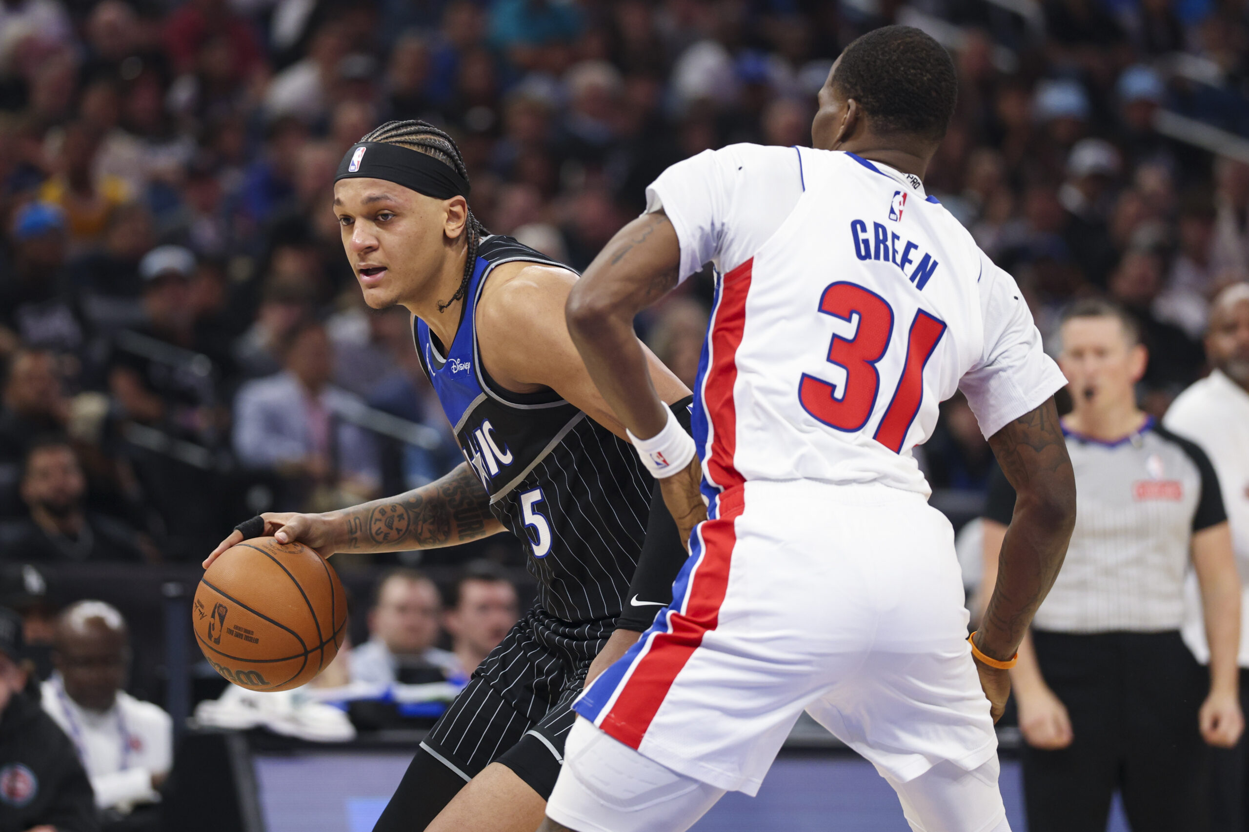 Apr 25, 2026; Orlando, Florida, USA; Orlando Magic forward Paolo Banchero (5) is guarded by Detroit Pistons guard Javonte Green (31) in the third quarter during game three of the first round of the 2026 NBA Playoffs at Kia Center. Mandatory Credit: Nathan Ray Seebeck-Imagn Images