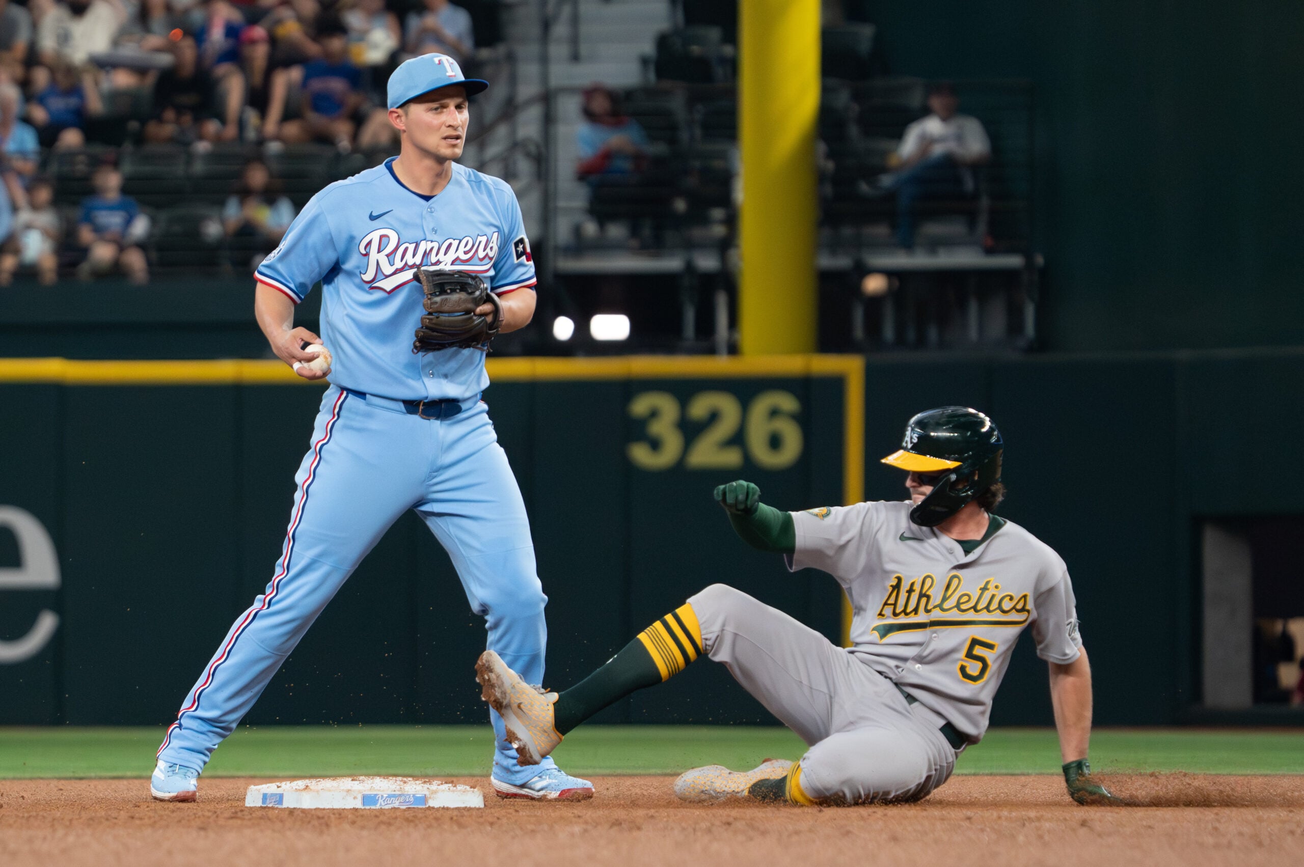 Apr 26, 2026; Arlington, Texas, USA;  Texas Rangers shortstop Corey Seager (5) forces Athletics shortstop Jacob Wilson (5) out at second base during the fourth inning at Globe Life Field. Mandatory Credit: Raymond Carlin III-Imagn Images