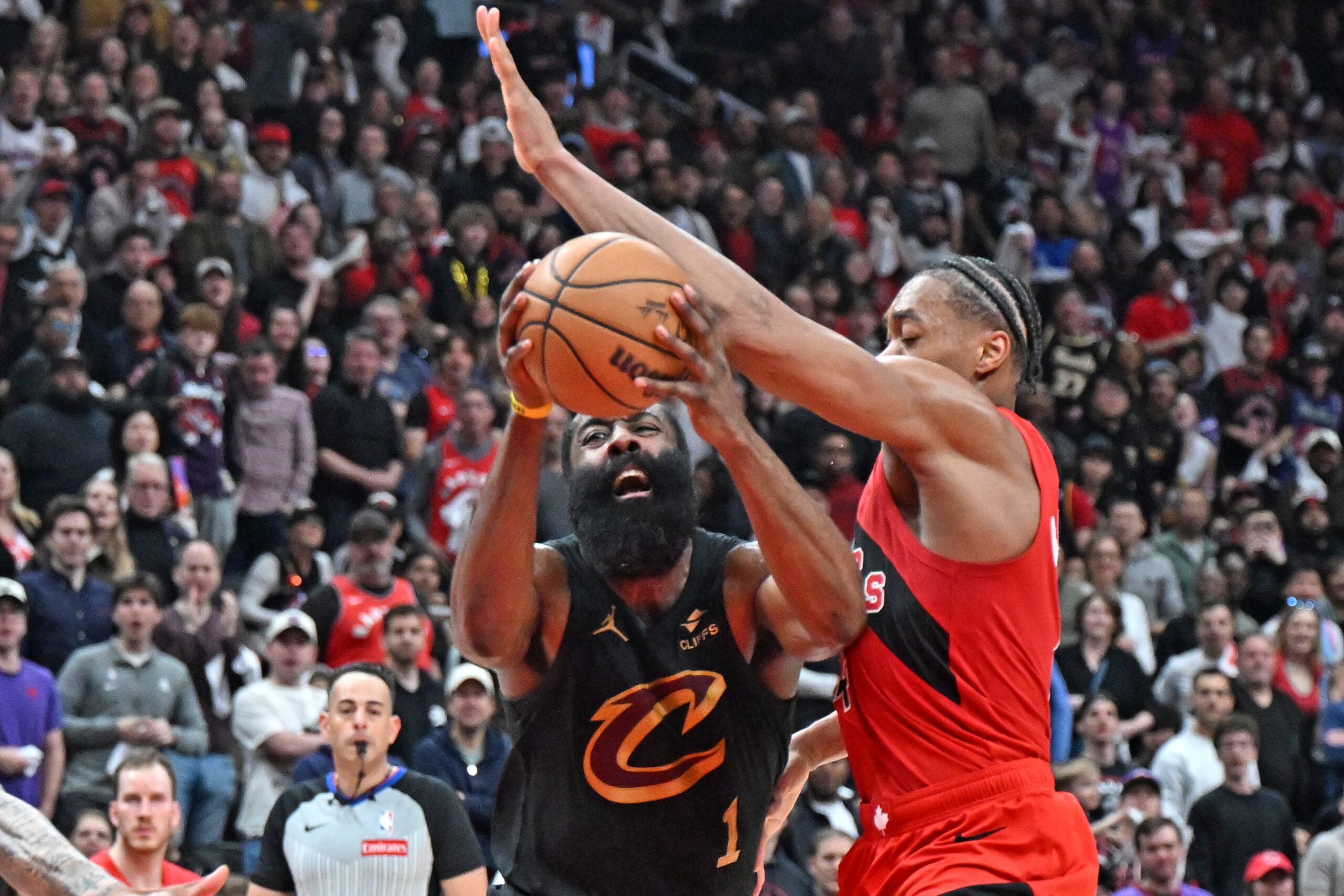 Apr 26, 2026; Toronto, Ontario, CAN;  Cleveland Cavaliers guard James Harden (1) battles for the ball with Toronto Raptors forward Scottie Barnes (4) during game four of the first round of the 2026 NBA Playoffs at Scotiabank Arena. Mandatory Credit: Dan Hamilton-Imagn Images