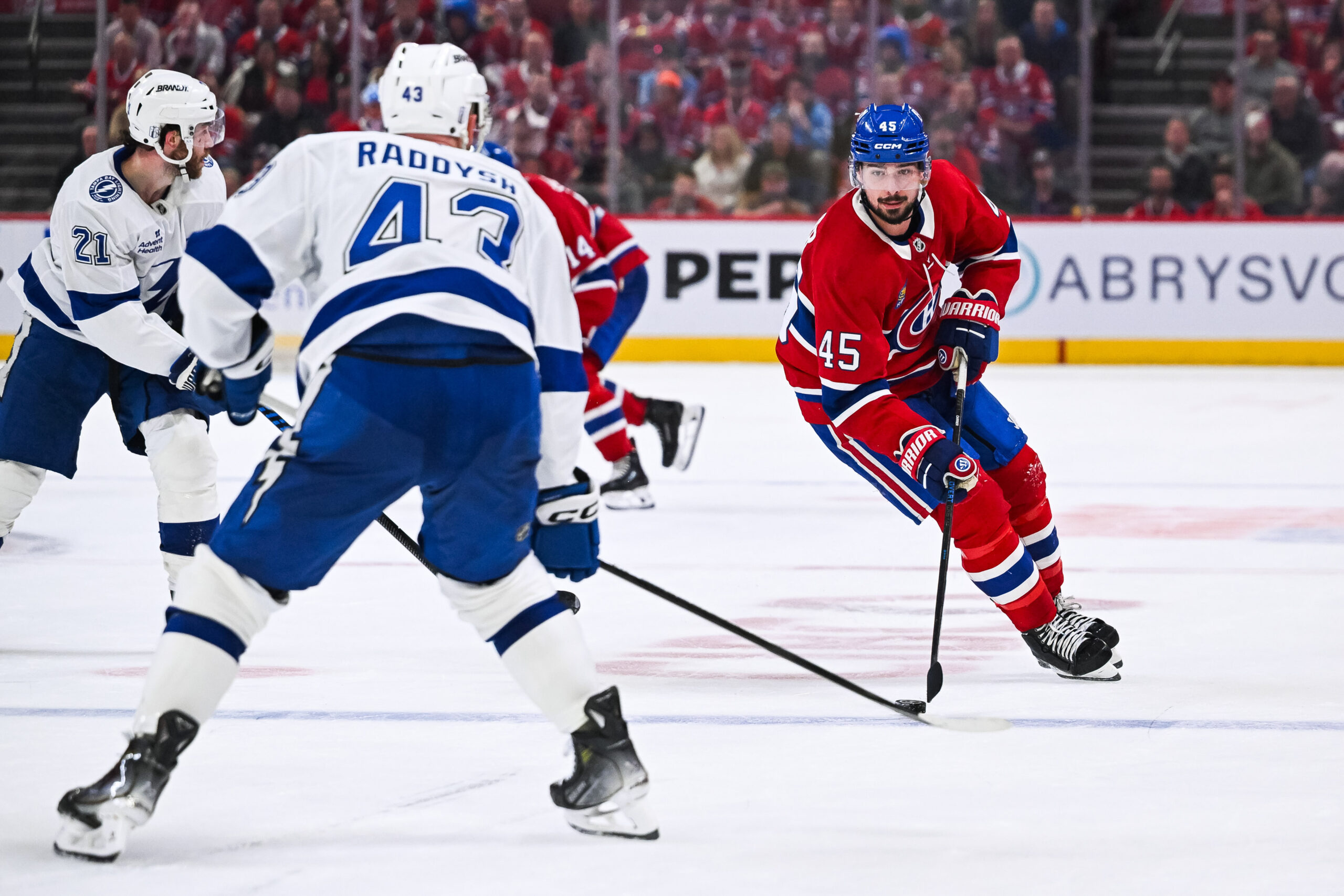 Apr 26, 2026; Montreal, Quebec, CAN; Montreal Canadiens defenseman Alexandre Carrier (45) plays the puck against Tampa Bay Lightning defenseman Darren Raddysh (43) during the third period in game four of the first round of the 2026 Stanley Cup Playoffs at Bell Centre. Mandatory Credit: David Kirouac-Imagn Images
