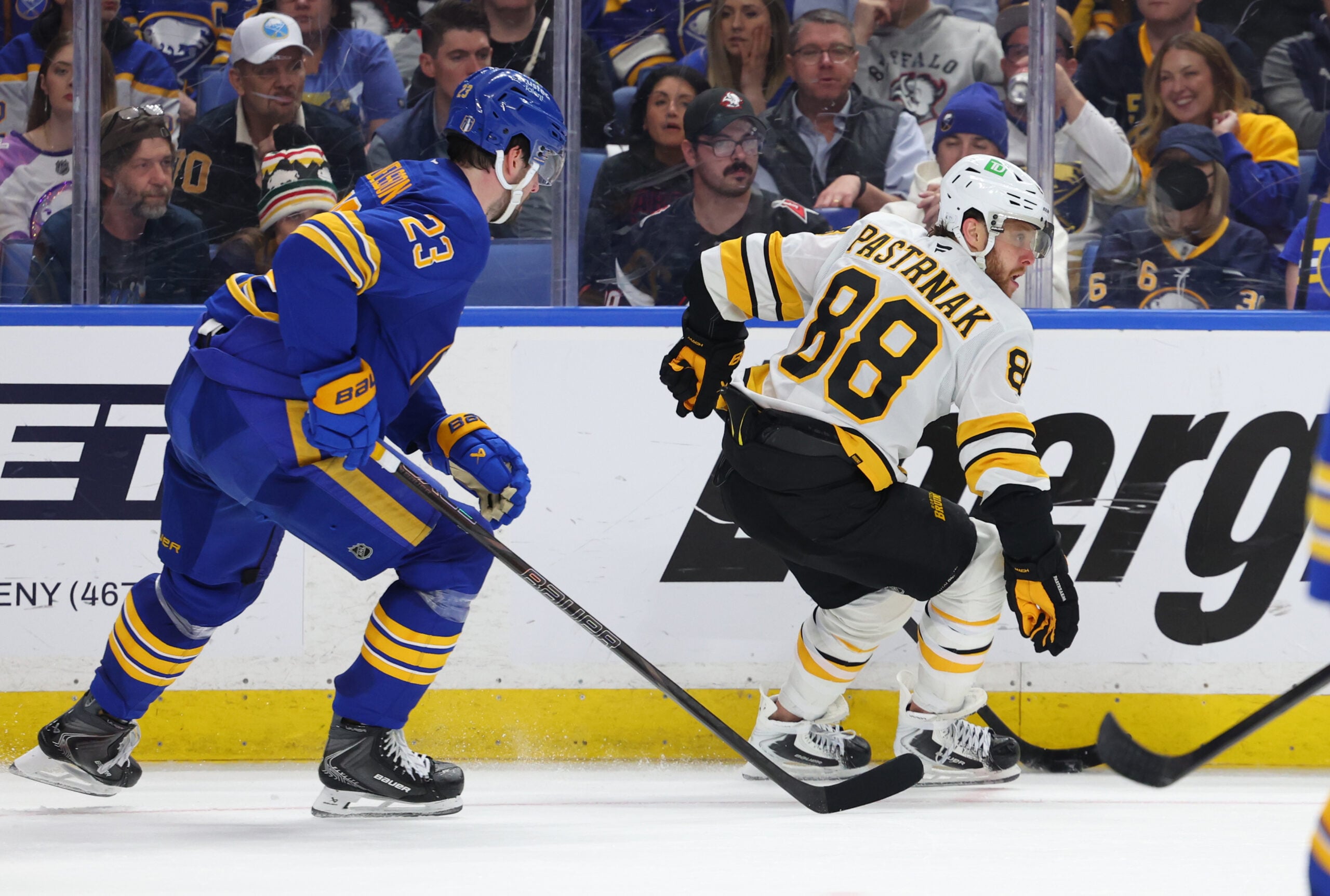 Apr 28, 2026; Buffalo, New York, USA; Boston Bruins right wing David Pastrnak (88) controls the puck as Buffalo Sabres defenseman Mattias Samuelsson (23) defends during the third period in game five of the first round of the 2026 Stanley Cup Playoffs at KeyBank Center. Mandatory Credit: Timothy T. Ludwig-Imagn Images