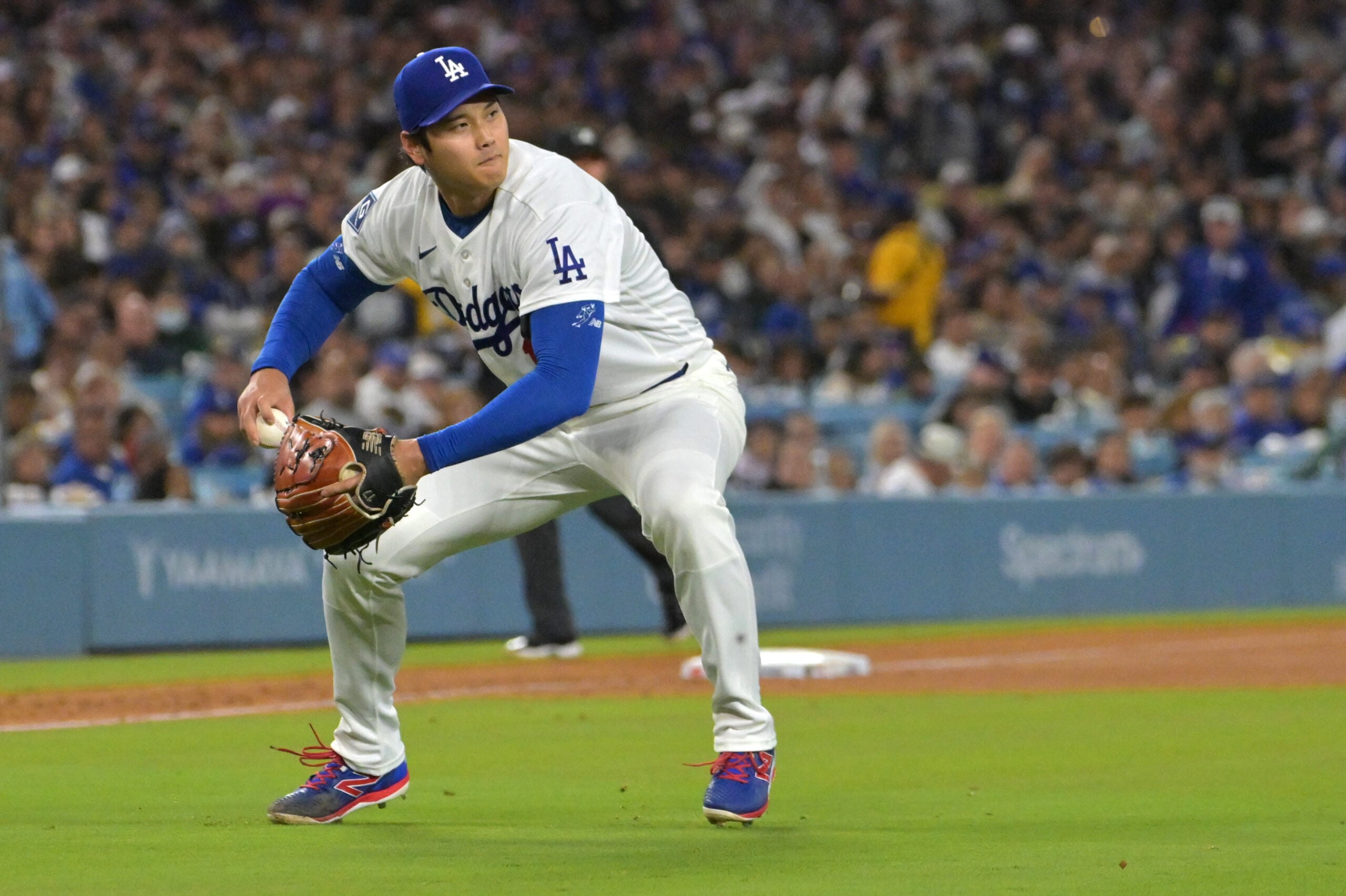 Apr 28, 2026; Los Angeles, California, USA; Los Angeles Dodgers starting pitcher Shohei Ohtani (17) makes a play to throw Miami Marlins center fielder Jakob Marsee (87) out at first base in the fifth inning at Dodger Stadium. Mandatory Credit: Jayne Kamin-Oncea-Imagn Images
