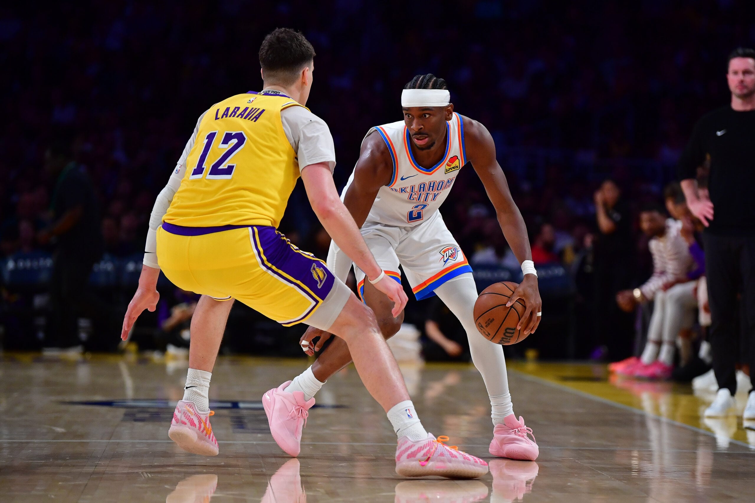 April 7, 2026; Los Angeles, California, USA; Oklahoma City Thunder guard Shai Gilgeous-Alexander (2) moves the ball against Los Angeles Lakers forward Jake LaRavia (12) during the second half at Crypto.com Arena. Mandatory Credit: Gary A. Vasquez-Imagn Images