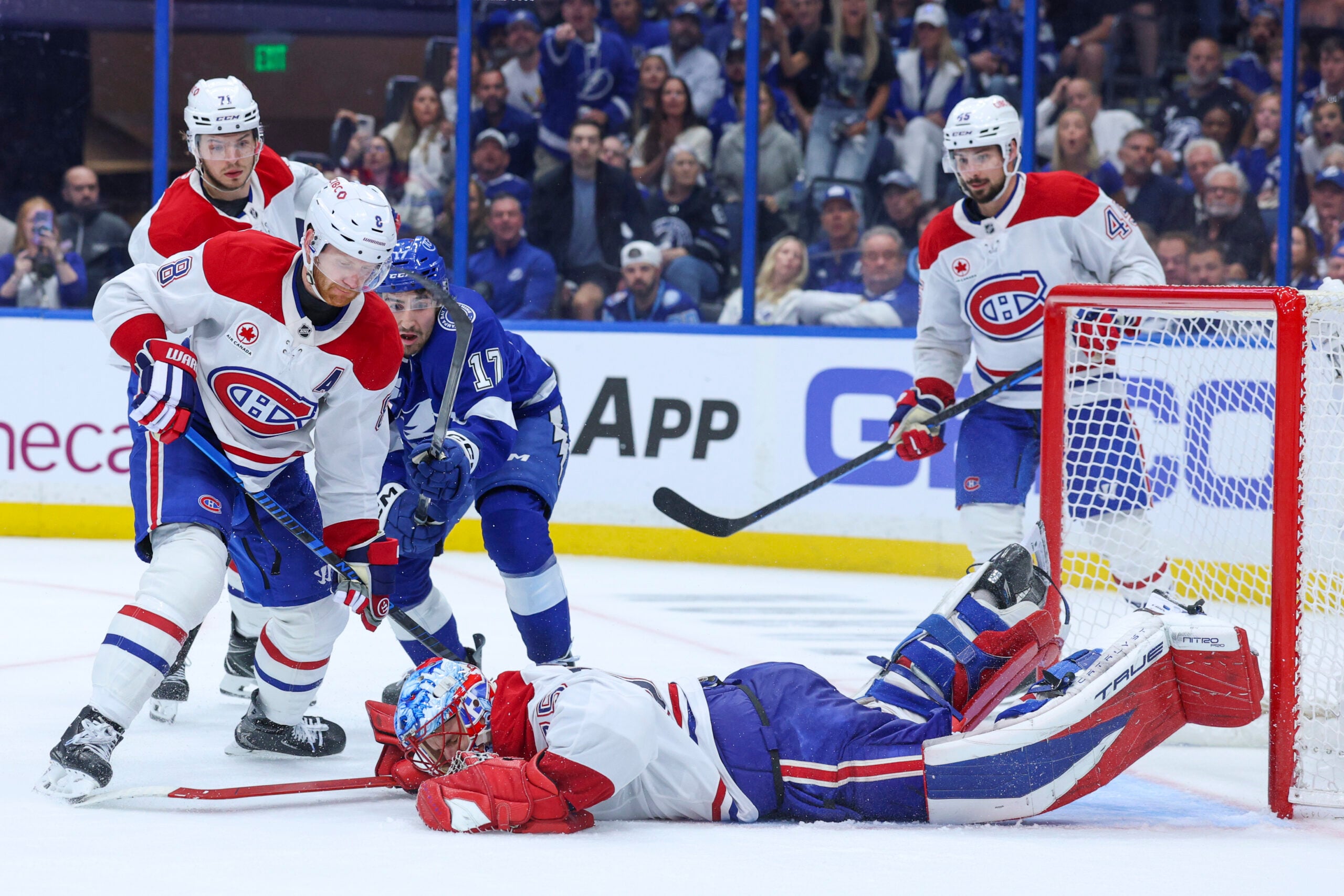 Apr 29, 2026; Tampa, Florida, USA; Montreal Canadiens goaltender Jakub Dobes (75) dives on the puck against the Tampa Bay Lightning in the third period during game five of the first round of the 2026 Stanley Cup Playoffs at Benchmark International Arena. Mandatory Credit: Nathan Ray Seebeck-Imagn Images