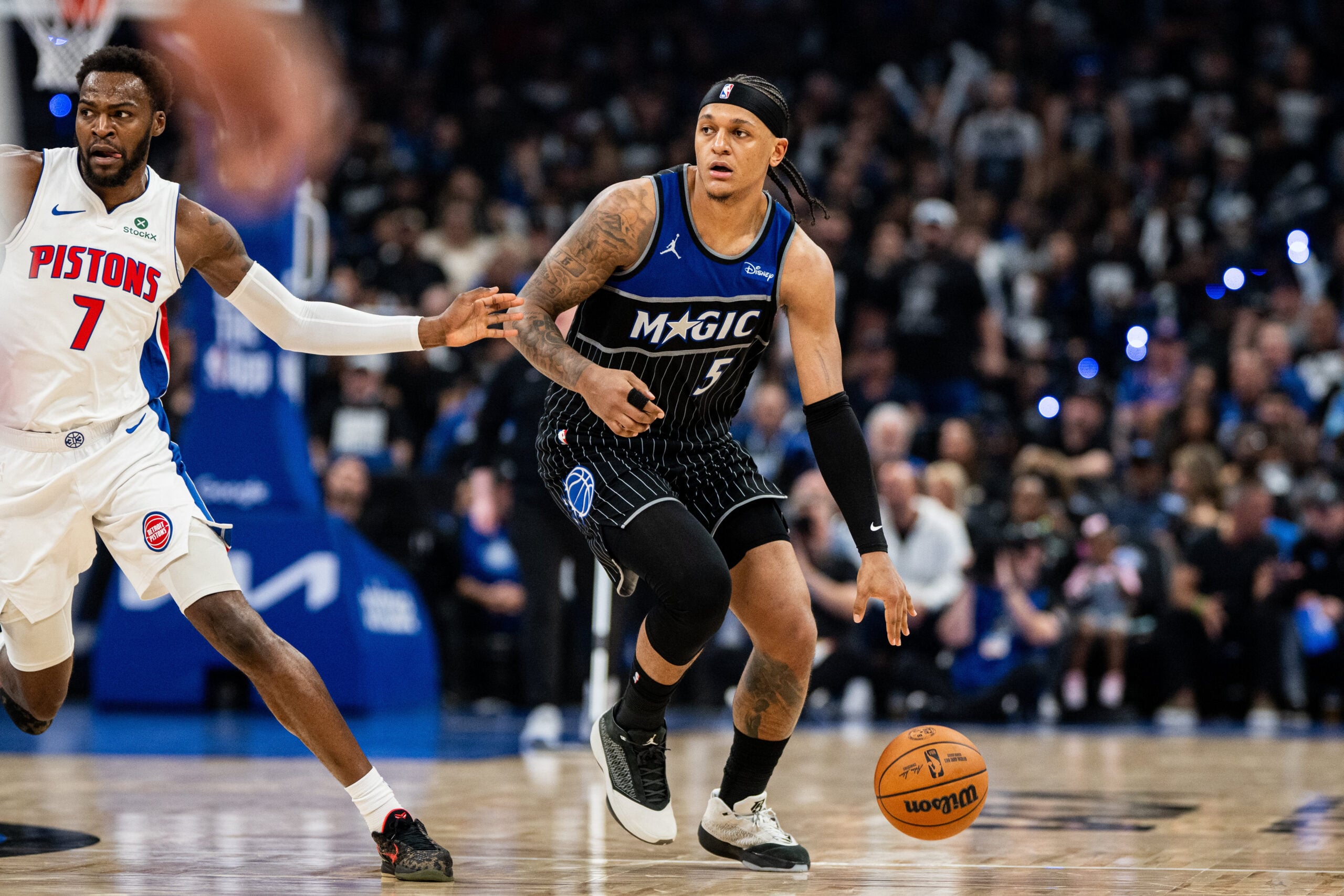 May 1, 2026; Orlando, Florida, USA; Orlando Magic forward Paolo Banchero (5) dribbles the ball against Detroit Pistons forward Paul Reed (7) in the fourth quarter during game six of the first round of the 2026 NBA Playoffs at Kia Center. Mandatory Credit: Jeremy Reper-Imagn Images