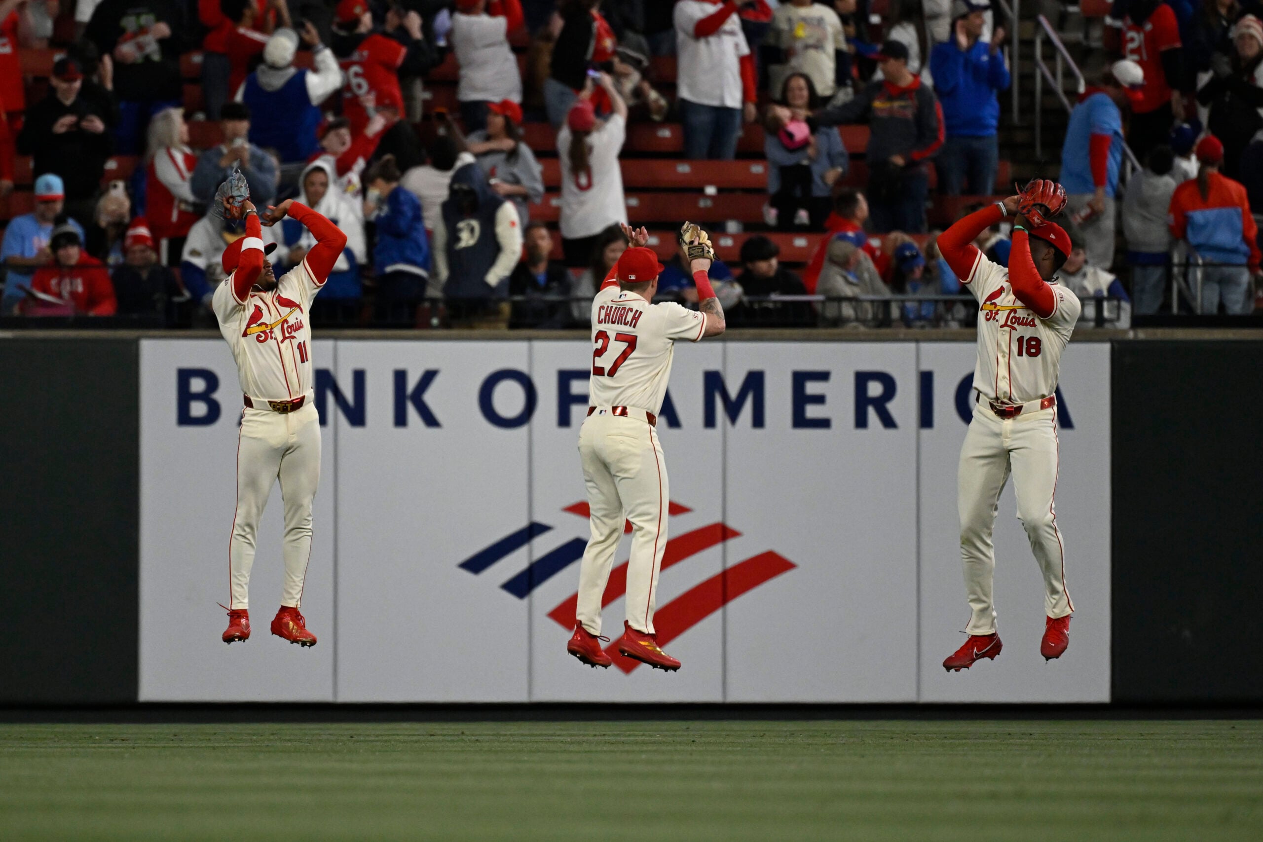 May 2, 2026; St. Louis, Missouri, USA; St. Louis Cardinals center fielder Victor Scott II (11), St. Louis Cardinals left fielder Nathan Church (27) and St. Louis Cardinals right fielder Jordan Walker (18) celebrate after beating the Los Angeles Dodgers at Busch Stadium. Mandatory Credit: Joe Puetz-Imagn Images