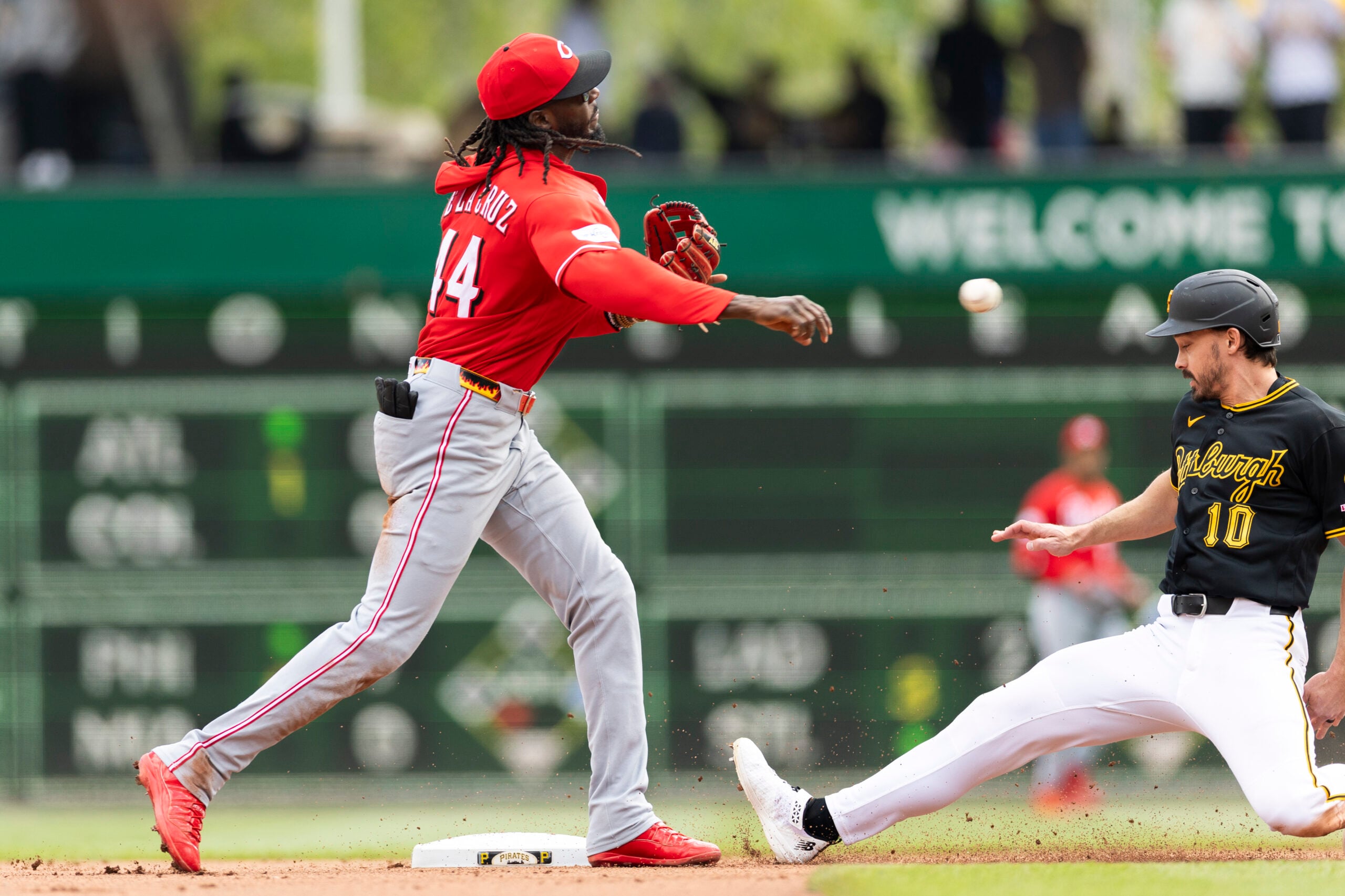 May 3, 2026; Pittsburgh, Pennsylvania, USA;  Cincinnati Reds shortstop Elly De La Cruz (44) makes the throw to complete a double play as Pittsburgh Pirates left fielder Bryan Reynolds (10) slides into second base during the seventh inning at PNC Park. Mandatory Credit: Scott Galvin-Imagn Images