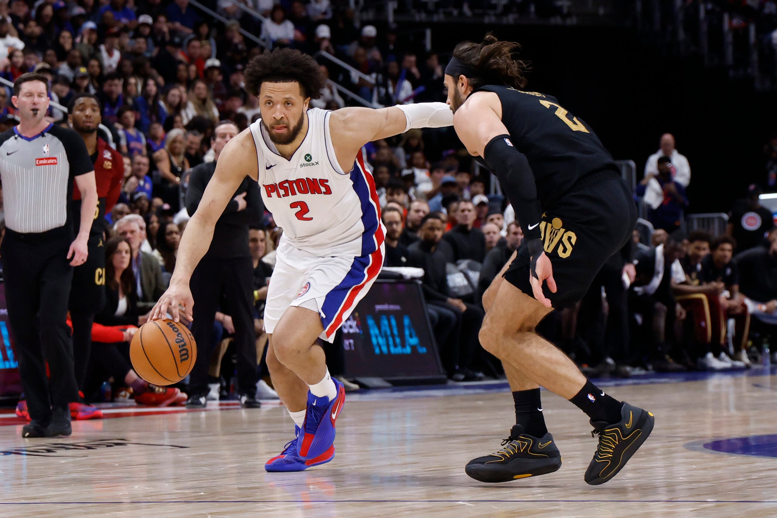 May 5, 2026; Detroit, Michigan, USA; Detroit Pistons guard Cade Cunningham (2) dribbles defended by Cleveland Cavaliers guard Max Strus (2) in the second half during game one of the second round of the 2026 NBA Playoffs at Little Caesars Arena. Mandatory Credit: Rick Osentoski-Imagn Images