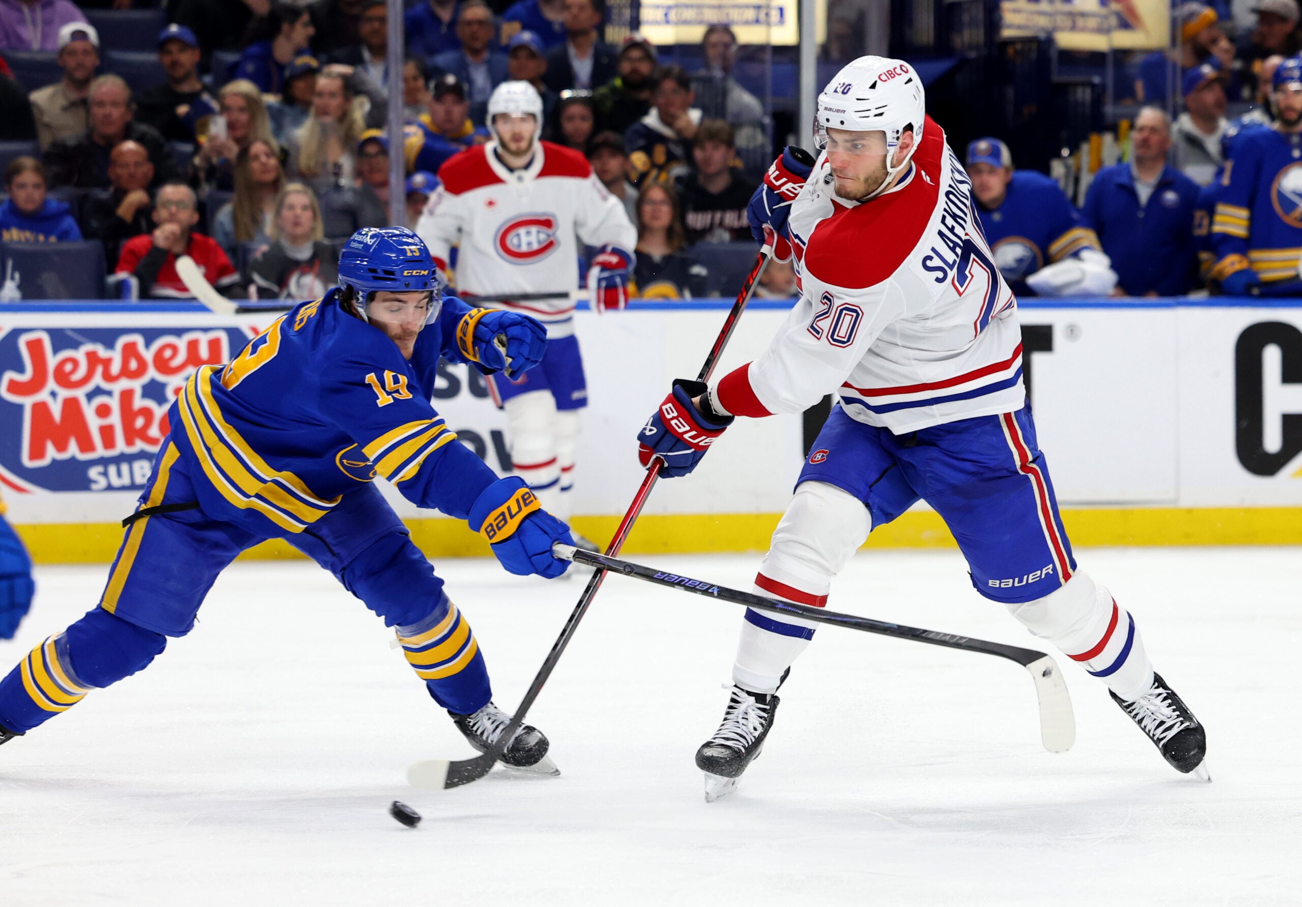May 6, 2026; Buffalo, New York, USA; Buffalo Sabres center Peyton Krebs (19) tries to block a shot by Montréal Canadiens left wing Juraj Slafkovský (20) during the third period in game one of the second round of the 2026 Stanley Cup Playoffs at KeyBank Center. Mandatory Credit: Timothy T. Ludwig-Imagn Images